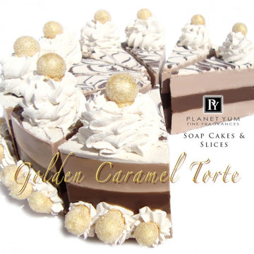 Whole natural goat milk soap cake called Golden Caramel Torte with beautiful caramel & white tones and soap piping with glittering golden balls on cream puffs.
